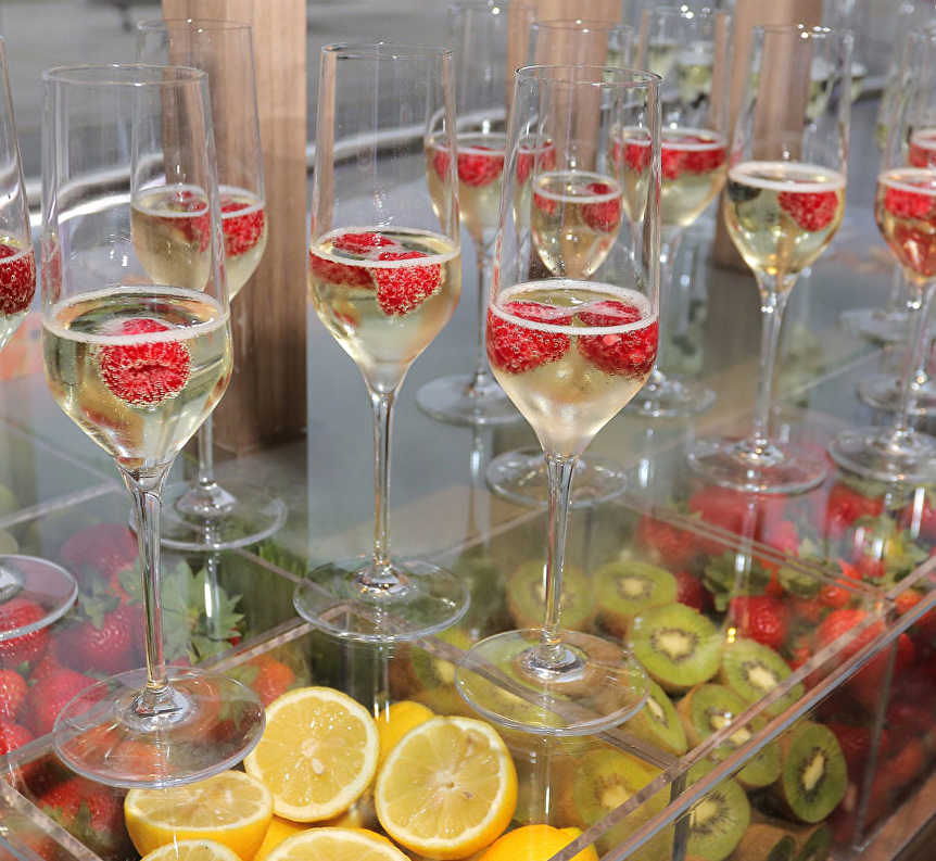 a group of glasses filled with champagne and fruit