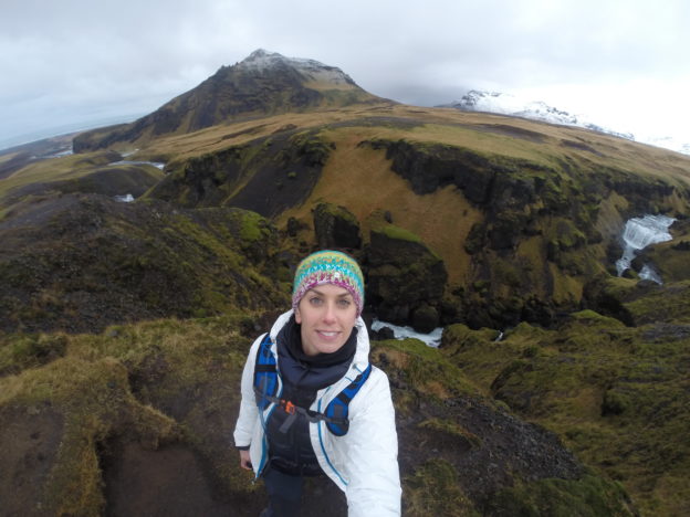 a woman taking a selfie on a mountain