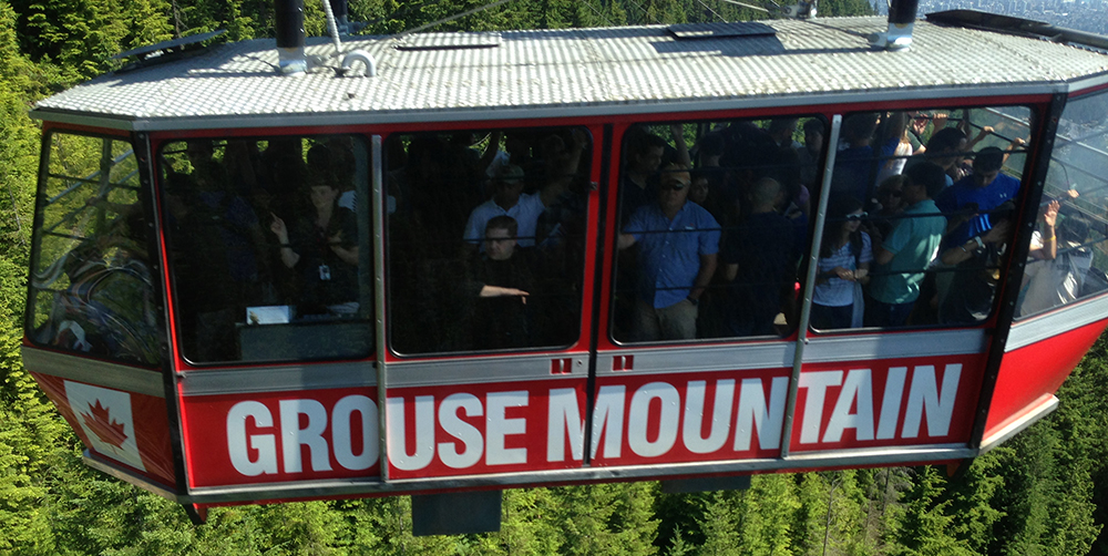 a group of people on a cable car