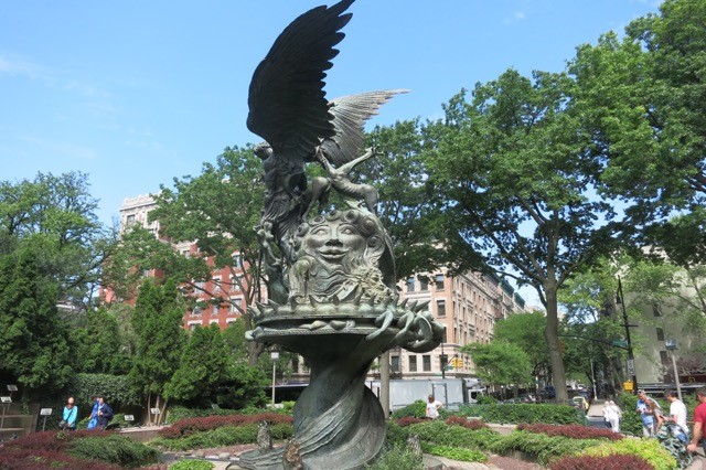 a statue of a bird on a fountain