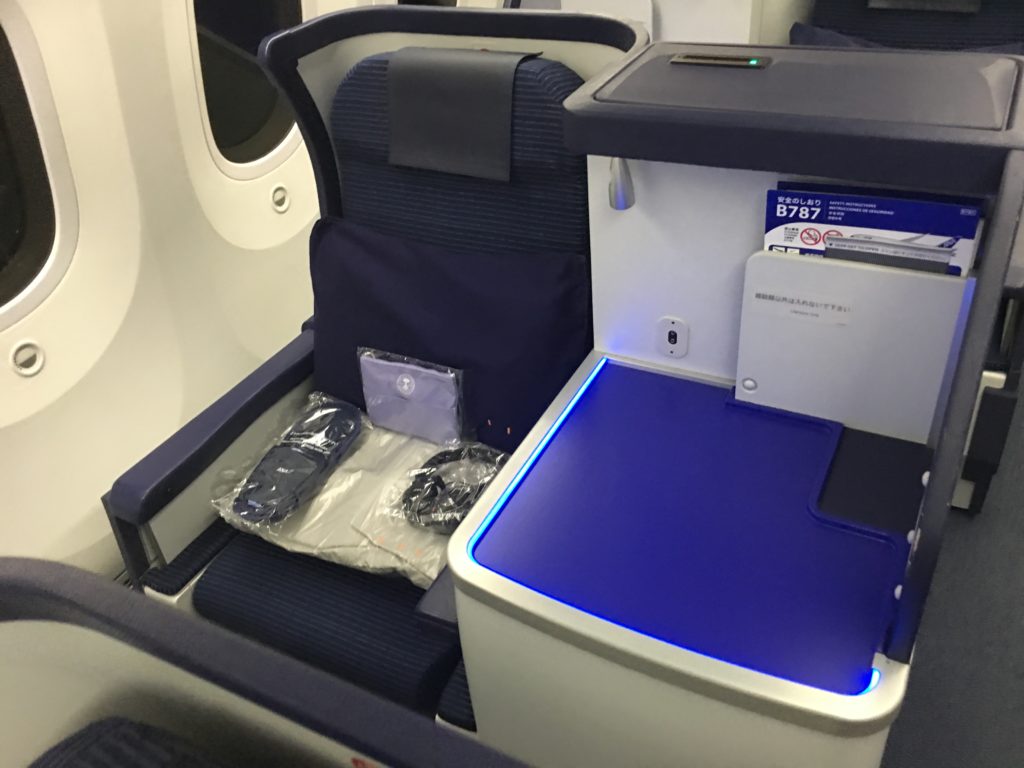 an airplane seat with a blue light