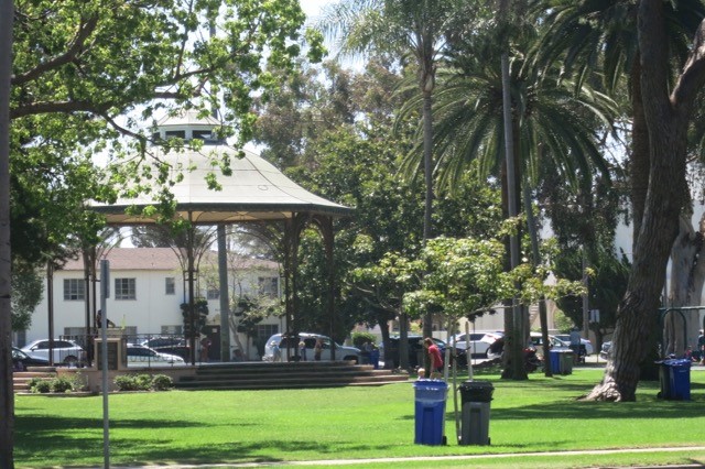 a park with a gazebo and palm trees