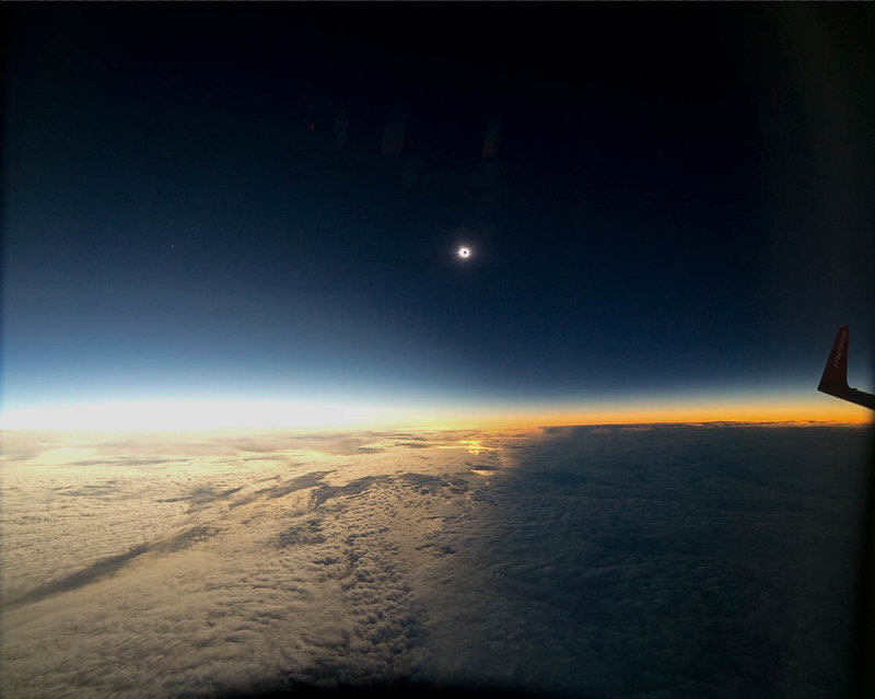a view of the sun and clouds from the sky