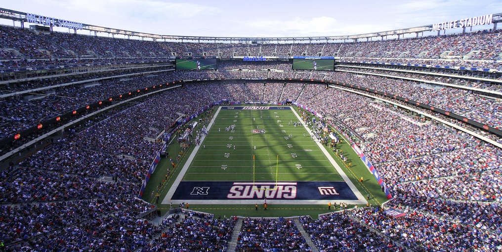 a stadium full of people with MetLife Stadium in the background