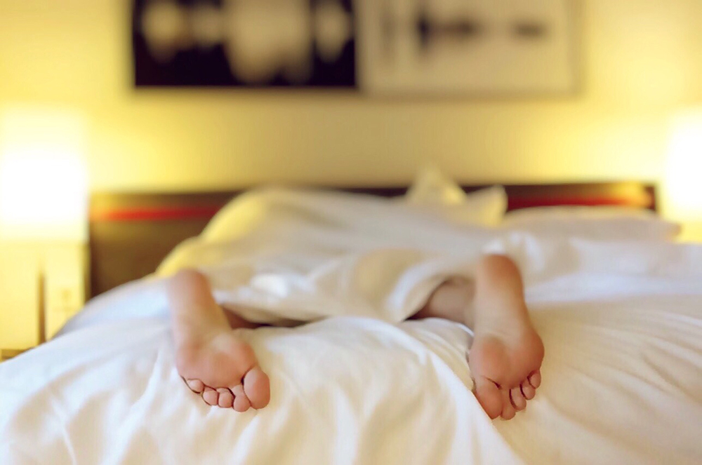 a person's feet on a bed
