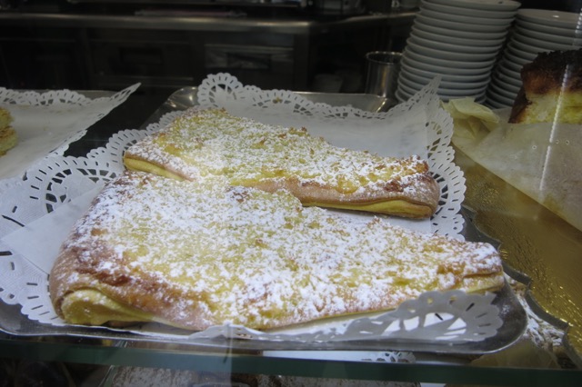 a plate of pastries with powdered sugar