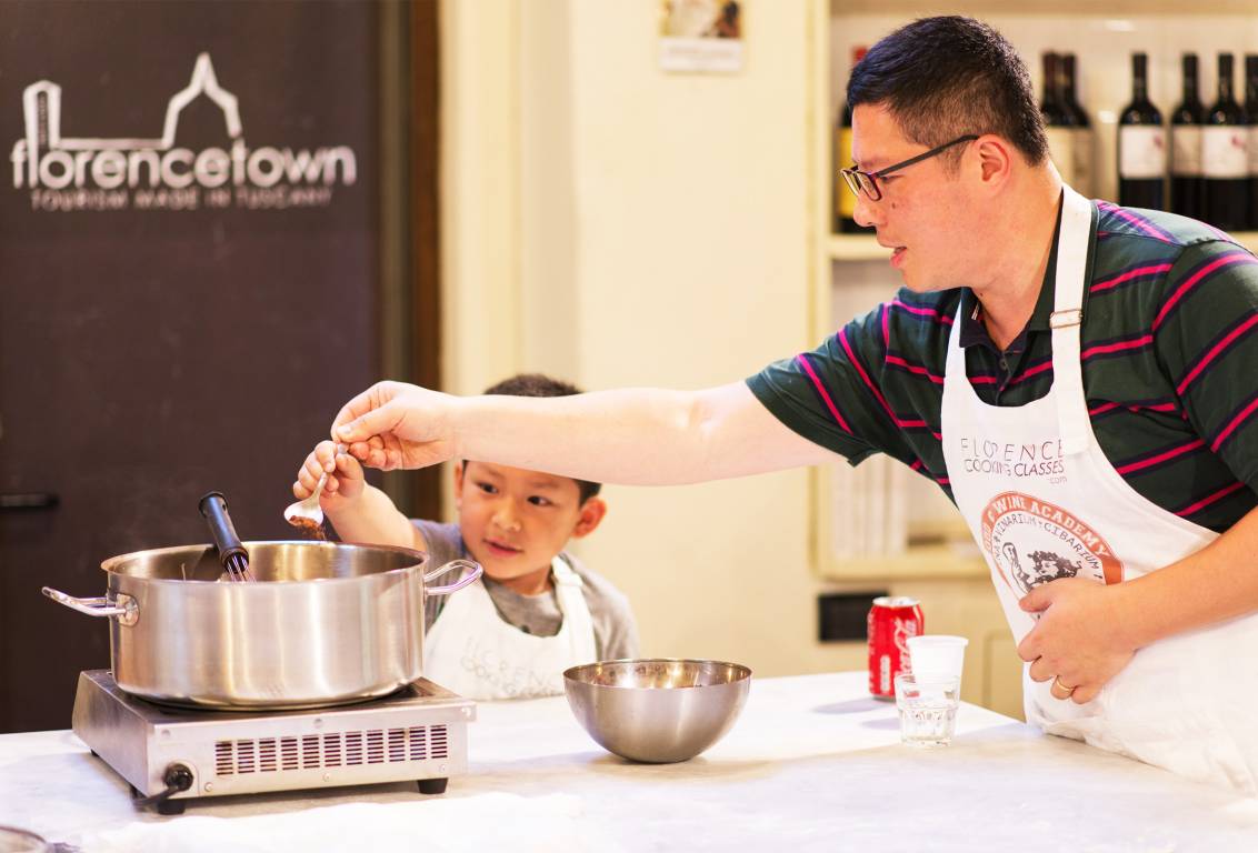 a man and child cooking