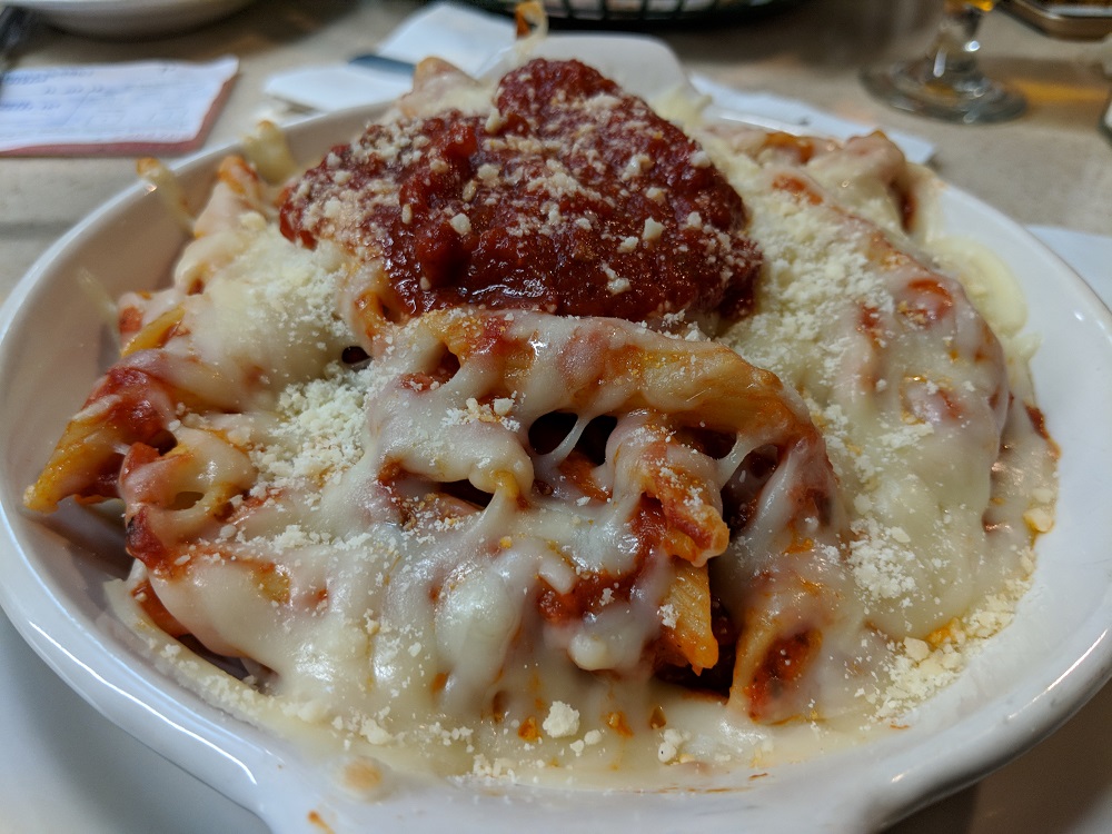 a bowl of pasta with sauce and cheese