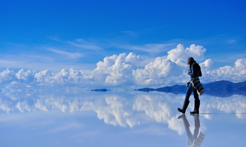 a man walking on a reflective surface