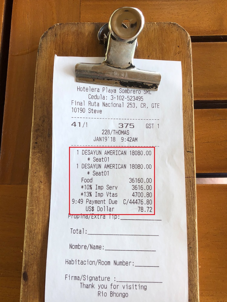 a receipt on a wood surface