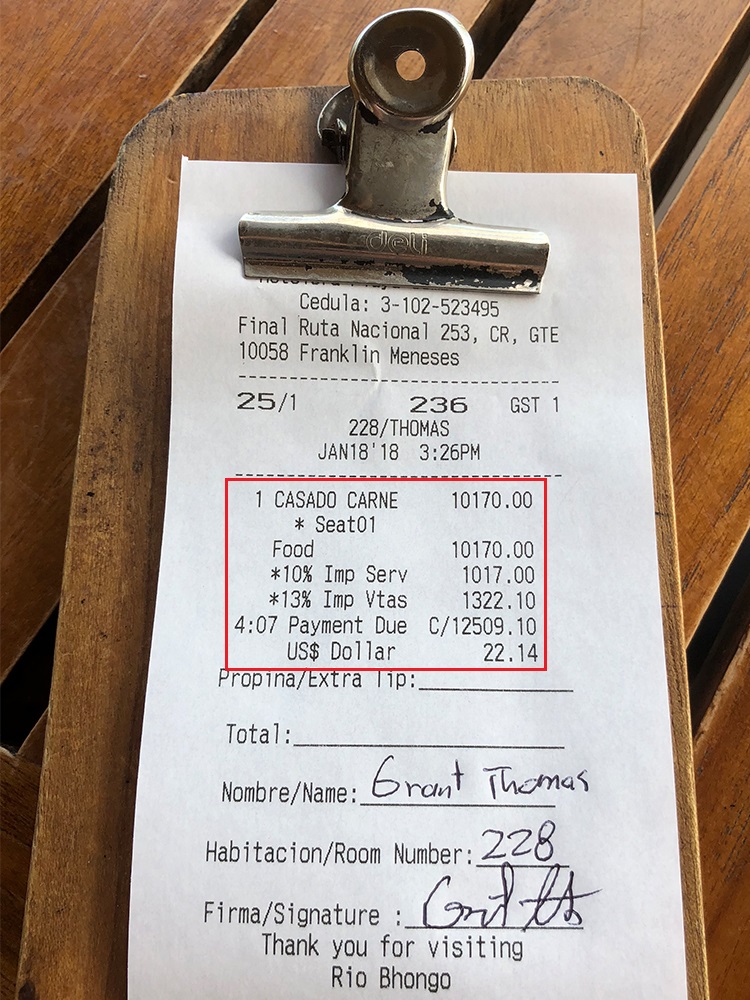 a receipt with a clip on a wood surface