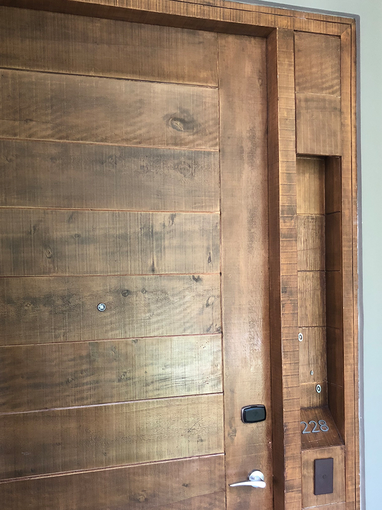 a wooden door with a shelf