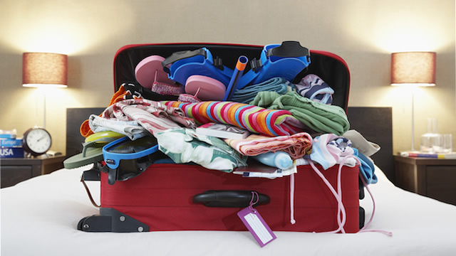 a suitcase full of clothes and flip flops