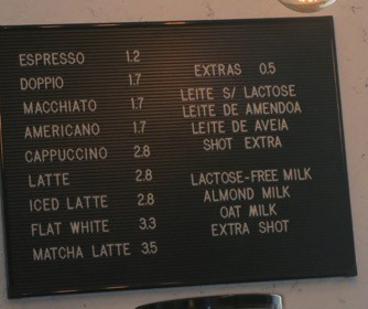 a sign with a list of coffee