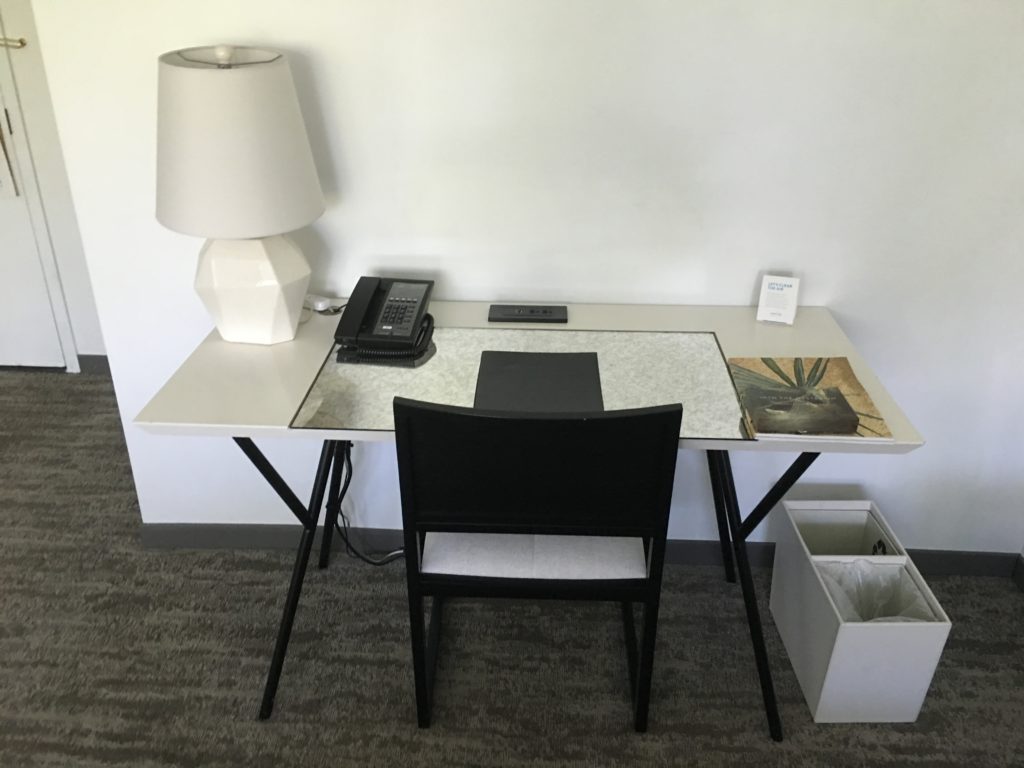 a desk with a chair and a phone on it