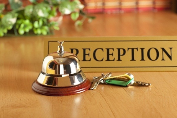 a reception bell and keys on a desk