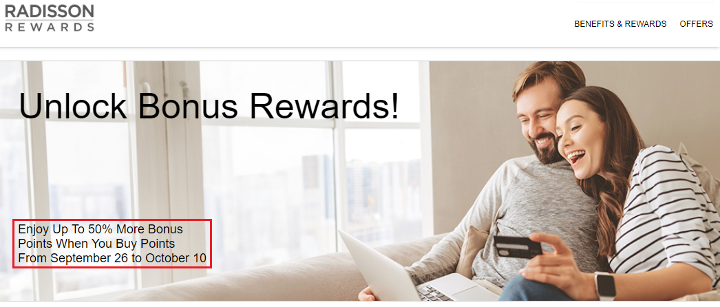 a woman sitting on a couch holding a laptop and credit card