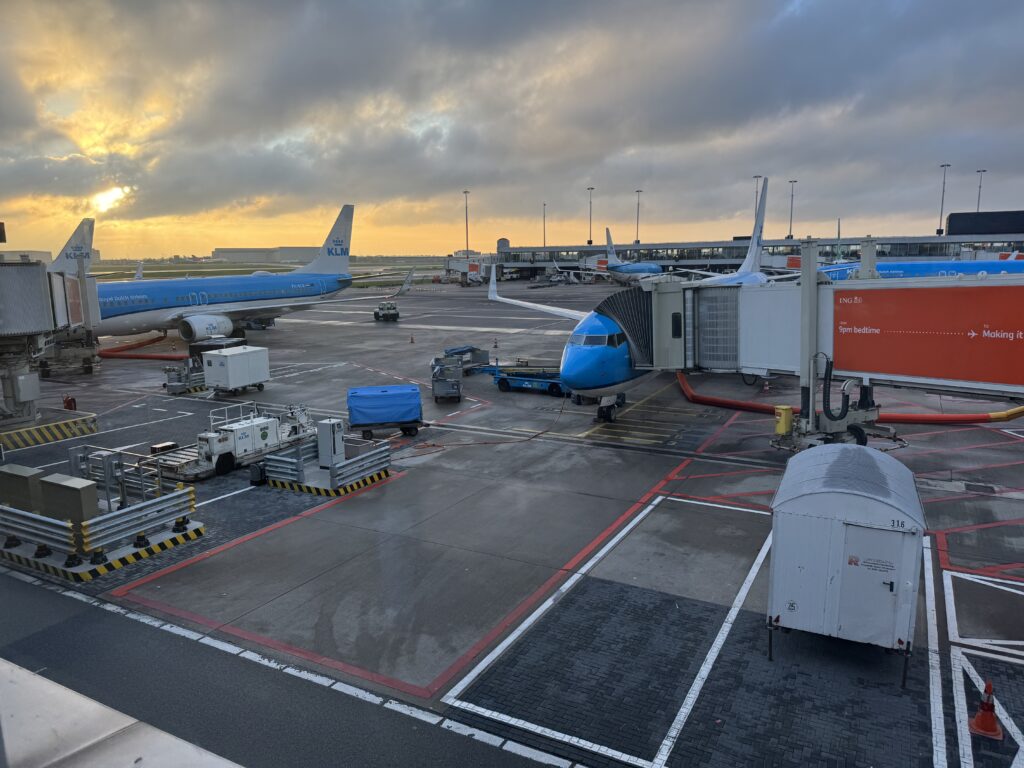 an airport with airplanes and a bridge